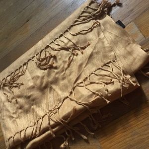 Gold colored shawl with fringes.